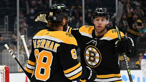 Boston Bruins right wing David Pastrnak (88) celebrates with left wing Taylor Hall (71).